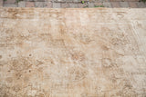 Blanched Vintage Oushak carpet featuring faded geometric patterns, subtle wheat tones, and authentic repairs.