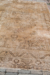 Blanched vintage Oushak carpet showing intricate linear patterns and authentic textural wear.