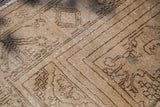 Blanched vintage Oushak rug with geometric drawing, textured pile, and authentic repair.