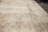 Blanched vintage Oushak rug, sun-faded wheat tones, and authentic muted patterns.