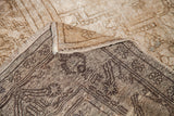 Vintage Oushak carpet's blanched wheat pile contrasted by its dark woven back.