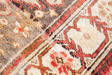 Vintage Oushak rug's blanket-like pile, featuring madder root red and charcoal bronze motifs.