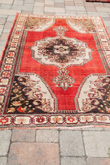 Textured fringe and patterned lower border of the vintage Oushak rug.