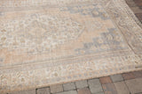Blanched vintage Oushak rug, showing soft, faded ivory and silver-lavender pile.