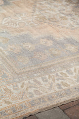 Soft, blanched texture of a vintage Oushak carpet with ivory, beige, and lavender patterns.