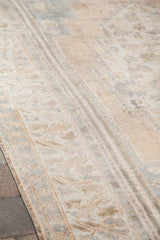 Blanched vintage Turkish Oushak rug detail, faded ivory and silver curvilinear border.