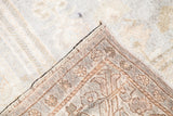 Vintage Oushak carpet corner detail, displaying soft blanched pile and hand-knotted foundation.