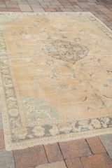 Mint-green corner spandrels and faded border detail on a vintage Oushak carpet.