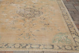Soft pastel earth-tones and unusual mint-green corner spandrel on vintage Oushak rug.