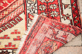 Vintage Turkish rug reverse, revealing hand-knotted foundation and cream fringe.