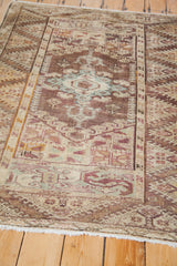 Pastel and earth-tone geometric patterns with blue accents on vintage Anatolian rug.