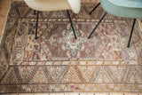 Vintage Anatolian rug with central geometric medallion in lilac, brown, and pastel teal.
