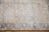 Light vintage Oushak rug pile with pastel floral motifs and subtle border design.