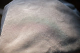 Close-up showing the finely ribbed texture of the light grey corduroy pillow backing.