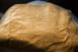 Close-up showing the rich texture of the mustard yellow velvet pillow backing.
