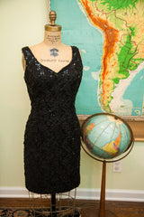 Short black sequined vintage 80s dress skirt on a mannequin.
