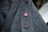 Vintage grey mink lambswool sweater texture and reddish-brown buttons.