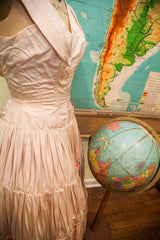 Blush pink 50s dress with ruched bodice, gathered taffeta skirt, and hot pink rosebuds.