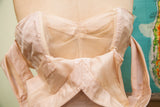 Blush pink 50s taffeta dress bodice featuring sheer mesh and structured pleating.