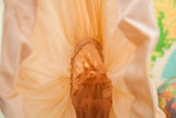 Sheer blush fabric layers and delicate textured inner lining of the 50s dress.