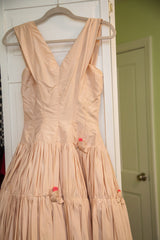 Voluminous blush pink taffeta skirt with hot pink rosebud detailing.