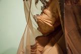 Close-up of the vintage brown gown's back sleeve lace separation detail.