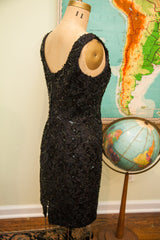 Vintage 80s black sequin dress, showcasing intricate textured shimmer, side view.