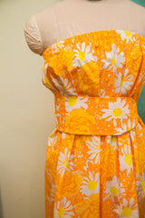 Matching belt and pleated skirt of the orange, white, yellow floral Lilly Pulitzer dress.
