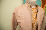 Vintage light pink leather jacket shoulder, showing vertical panel stitching and flap pocket.