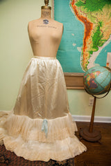 Ivory vintage bridal petticoat, tiered lace and net hem with light blue ribbon detail.