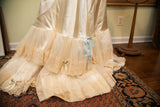Creamy vintage 50s bridal slip with tiered lace, ruffled tulle, and blue ribbon.