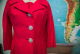 Large, sparkling rhinestone buttons on the bodice of a vintage hot pink dress coat.