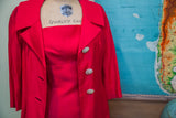 Sparkly rhinestone buttons and wide notched lapels on a vintage 60s hot pink coat.