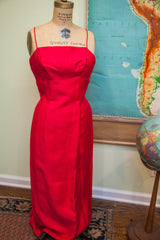 The hot pink dress from the vintage two-piece suit, with thin straps and a long, fitted shape.