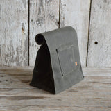 Moss green waxed canvas Marlowe Lunch Bag with rolled top and front pocket.