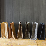 Marlowe Lunch Bags in waxed canvas, displayed in various neutral and dark colors.