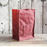 Dusty pink Marlowe Lunch Bag in textured waxed canvas with prominent exterior pocket.