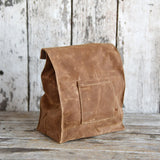 Peg and Awl Marlowe Lunch Bag Spice, brown waxed canvas with a front pocket.