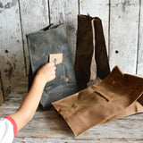 Marlowe lunch bag in Spice color and dark waxed canvas, showing pocket detail.