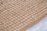 Detailed view of Martine Collection jute rug, showing its natural nubbly woven texture.