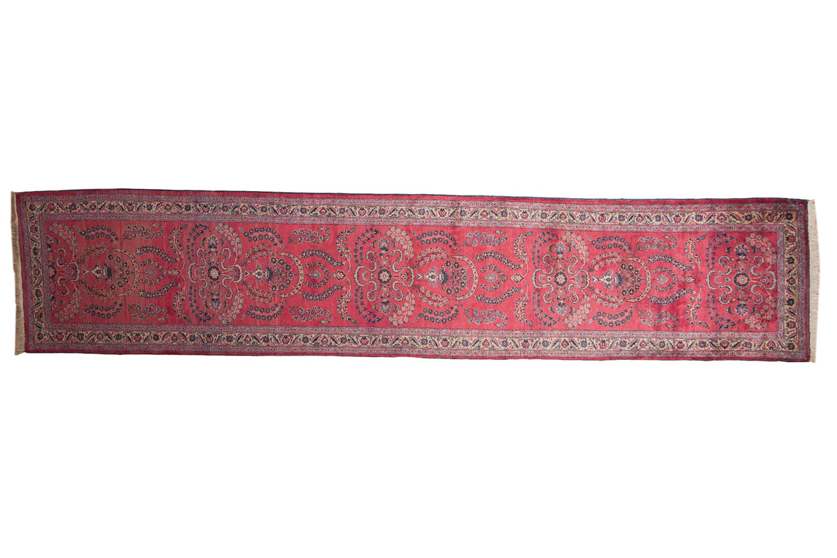 Vintage Persian Meshed runner with intricate Sarouk floral sprays and cloud-band motifs on a raspberry red field.