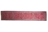 Vintage Persian Meshed runner with intricate Sarouk floral sprays and cloud-band motifs on a raspberry red field.