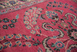 Intricate Sarouk floral sprays in sky blue and beige on the raspberry red pile of a vintage Persian runner.