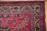 Corner detail of a vintage Meshed rug showing its cloud-band border and original side cord selvage.