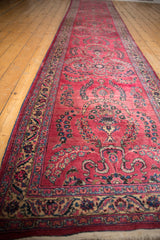Long perspective view of the raspberry red Persian runner's repeating floral sprays.
