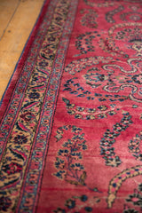 Intricate Sarouk floral sprays and beige border on a vintage raspberry red Persian runner.