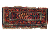 Antique Kurdish saddlebag rug with double medallions in madder red and indigo blue, framed by an intricate pawn motif border.