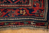 Intricate pawn motif and vine borders at the corner of an antique Kurdish rug with original fringe.