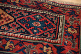 Intricate reciprocating pawn motif border and geometric medallion on a collector's antique Kurdish rug.