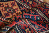 The rich, hand-knotted texture and detailed pawn motif border on an antique Kurdish collector rug.